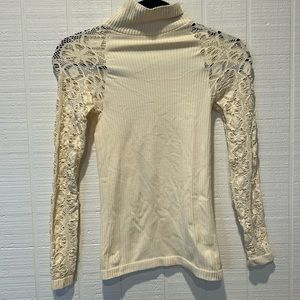 Free People cream ribbed turtleneck with cut outs in the sleeves